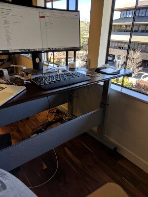 Image of a standing desk with an ultrawide monitor